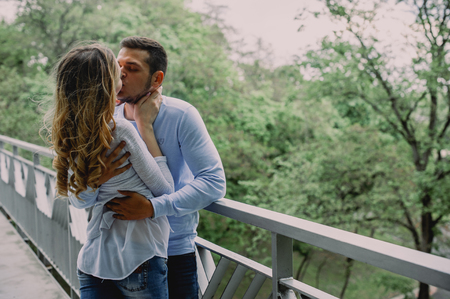 Beautiful young couple in a park. Summer outdoors.の写真素材