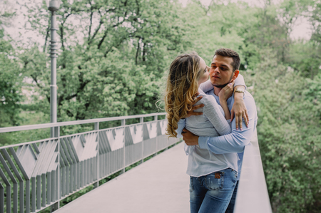 Beautiful young couple in a park. Summer outdoors.の写真素材