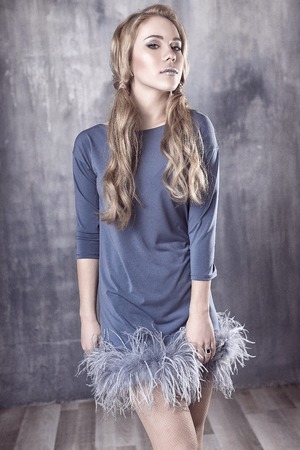 Young and emotional woman in fashion dress over glamour backgroundの写真素材