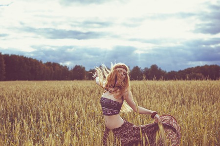 Hippie blone girl cheerful, peaceful and free. Summer timeの写真素材