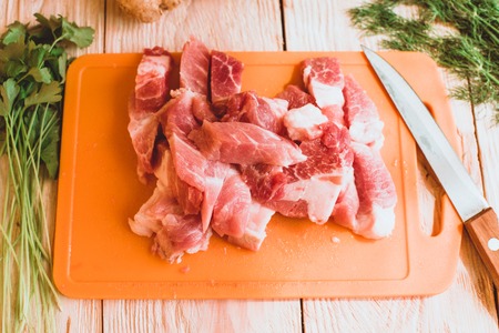 Food ingridients: red beans, carrot, cabbage, meat, onion, ginger for recipe stewed beans with meat on wooden background. Steps in cooking, process of preparing food. Concept of homemade healthy food. Flatlay, top viewの写真素材