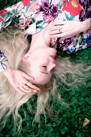 happy young blondie european woman on the grassの写真素材
