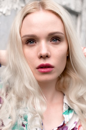 Young european blond woman outdoors portrait. Bright white colors.の写真素材
