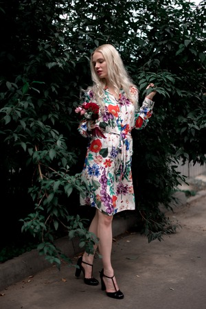 happy young blondie european woman on the grassの写真素材