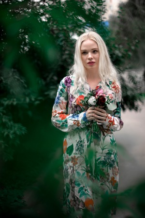 happy young blondie european woman on the grass