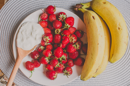 Bunch of bananas and strawberries.  Concept of healthy breakfast.の写真素材