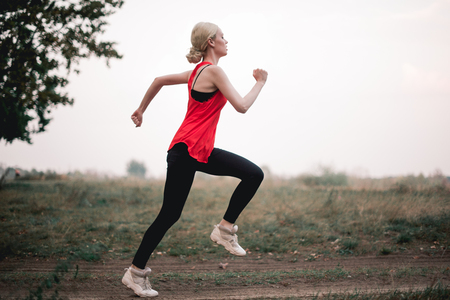 Young woman jogging at parkの写真素材