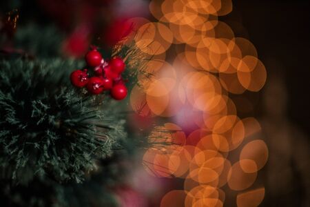 decorating christmas tree at home. Ornament close up on background of christmas tree with colorful...