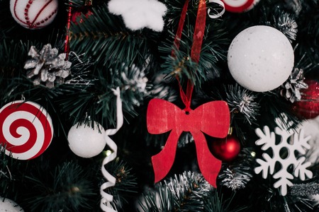 decorating christmas tree at home. Ornament close up on background of christmas tree with colorful...