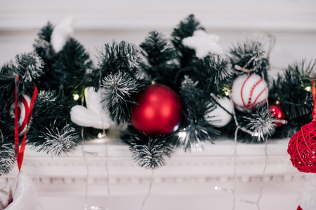 A close picture of beautifully decorated bright red Christmas socks hanging on a fireplace waiting for presents.の写真素材