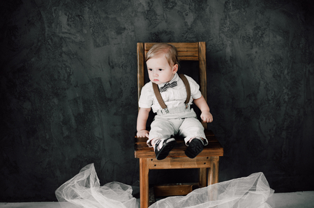 baby boy sitting on a chairの写真素材