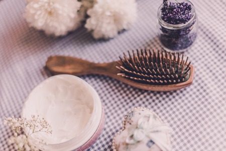 Natural spa set for woman. Hair care, pampering. Wooden comb, cream. Flat lay photography, top view, wooden backgroundの写真素材