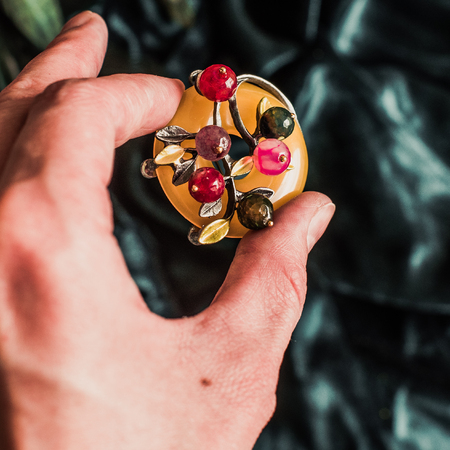 Vintage metal colorful brooch on velvet backgroundの写真素材