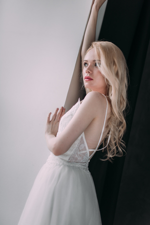 Portrait of a beautiful blond girl in image of the bride . Beauty face. Photo shot in the Studio on a grey backgroundの写真素材