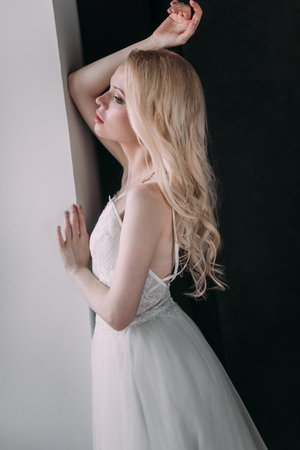 Portrait of a beautiful blond girl in image of the bride . Beauty face. Photo shot in the Studio on a grey backgroundの写真素材
