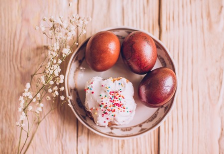 Easter table with traditional Easter cakes and Easter eggs with blossoming tree branch, religion