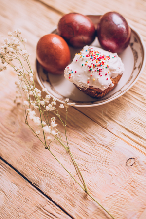 Easter table with traditional Easter cakes and Easter eggs with blossoming tree branch, religion