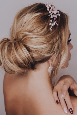 Beautiful young girl with purple or violet make up and healthy blonde hair. clean soft body products. Beauty Portrait. Woman Touching. Perfect Fresh Skin. Youth and Skin Care Concept. Fashion spring portraitの写真素材