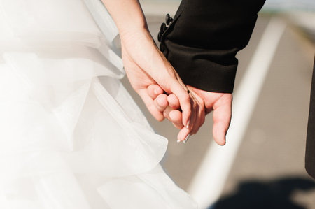 Portrait of a smiling married couple walking on a countryside roadの写真素材