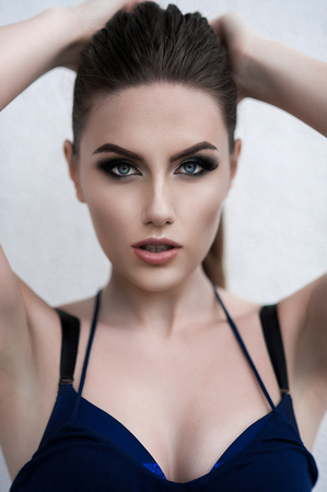 Pretty young sexy street fashion sensual woman posing outside dressed in blue robe outfitの写真素材