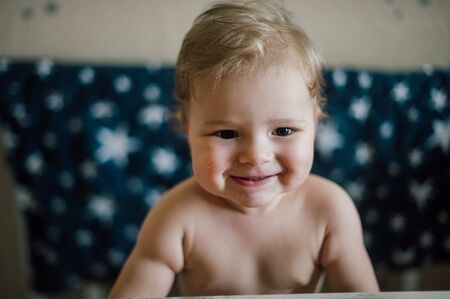 Baby boy sitting in the cribの写真素材