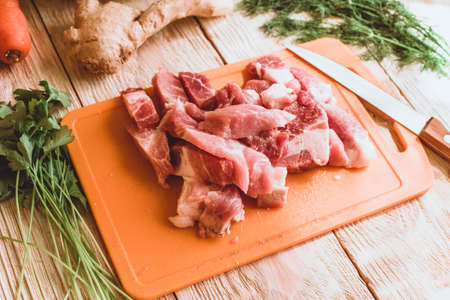 Food ingridients: red beans, carrot, cabbage, meat, onion, ginger for recipe stewed beans with meat on wooden background. Steps in cooking, process of preparing food. Concept of homemade healthy food. Flatlay, top viewの写真素材
