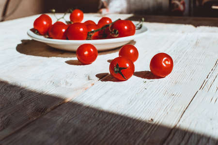Cherry tomatoes on wooden table background with copy space, flat layの写真素材