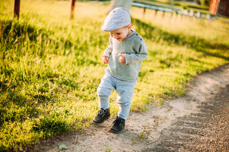 Baby boy 1-2 years old exploring nature in summer, having fun