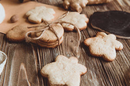 Close up of homemade ginger cookies, cinnamon, ginger on a wooden table. Copy space. Vintage toned image, flat layの写真素材