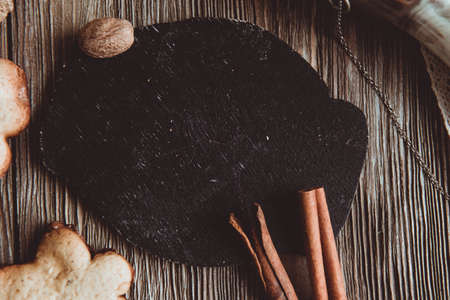 Close up of homemade ginger cookies, cinnamon, ginger on a wooden table. Copy space. Vintage toned image, flat layの写真素材
