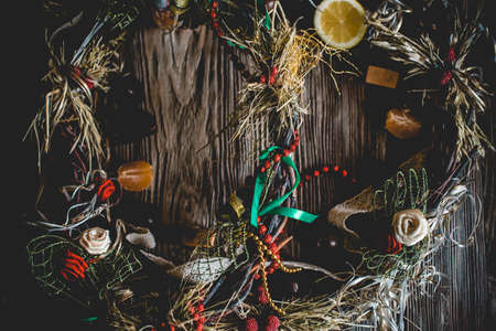 Creative Christmas wreath. An unusual idea for a holiday home decor. Natural interior decor on wooden background.の写真素材