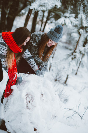 Two young teenage hipster girl friends together.Close up fashion portrait of two sisters hugs and...