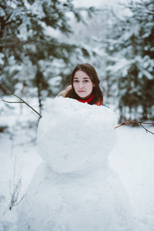 Two young teenage hipster girl friends together.Close up fashion portrait of two sisters hugs and having fun winter time,wearing sweater,best friends couple outdoors, snowy weatherの写真素材