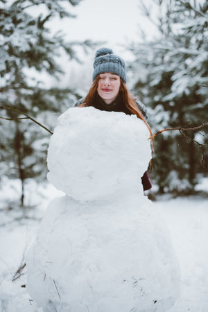 Two young teenage hipster girl friends together.Close up fashion portrait of two sisters hugs and having fun winter time,wearing sweater,best friends couple outdoors, snowy weatherの写真素材