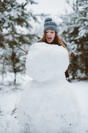 Two young teenage hipster girl friends together.Close up fashion portrait of two sisters hugs and having fun winter time,wearing sweater,best friends couple outdoors, snowy weatherの写真素材