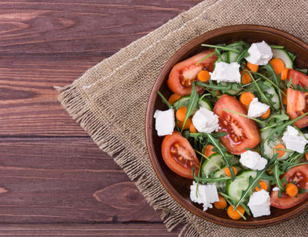 Vegetable salad with cheese feta in clay bowlの写真素材