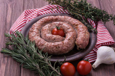Homemade baked sausage with spice and herbsの写真素材