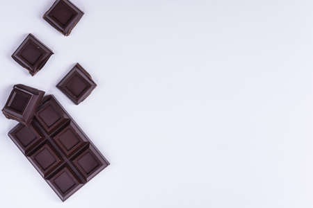 Broken chocolate bar slice on white backgroundの写真素材