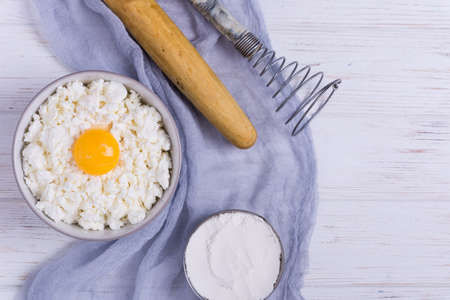 Cottage cheese with eggs,baking flour on white wooden rustic table