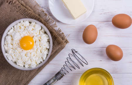Cottage cheese with eggs,baking flour on white wooden rustic tableの写真素材