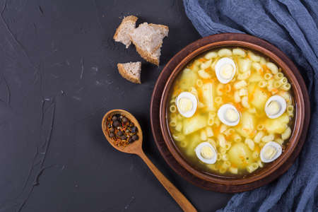 Soup with quail eggs with spice,herbs and vegetablesの写真素材