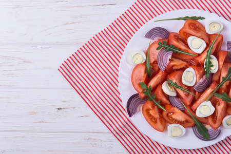 Salad with quail eggs,tomato,arugula,spice and purple onionの写真素材