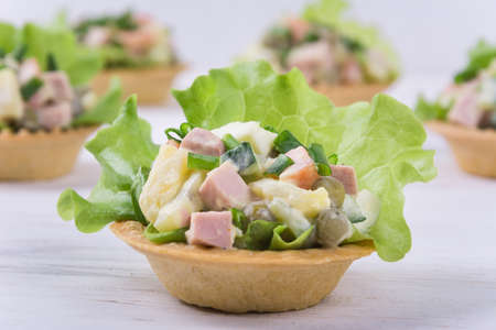 Traditional russian salad Olivier in tartlet with lettuce leavesの写真素材