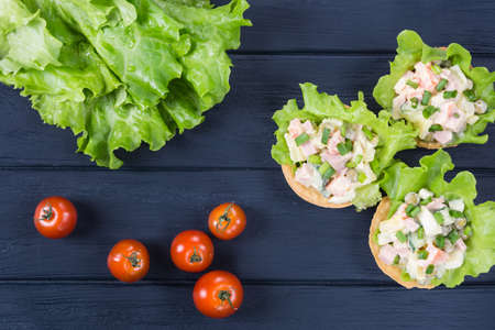 Traditional russian salad Olivier in tartlet with lettuce leavesの写真素材