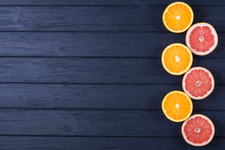 Orange and grapefruit slices on wooden backgroundの写真素材