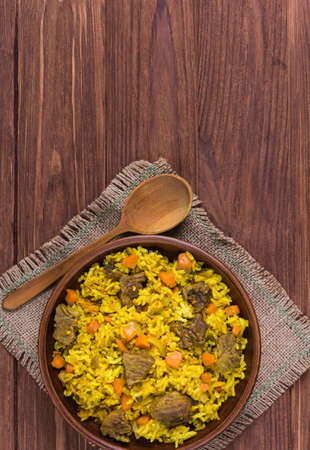 Pilaf the traditional dish of Asian cuisine with beef, carrot, onion, garlic, pepper and cumin