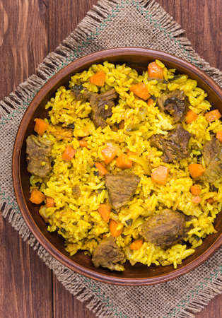 Pilaf the traditional dish of Asian cuisine with beef, carrot, onion, garlic, pepper and cumin
