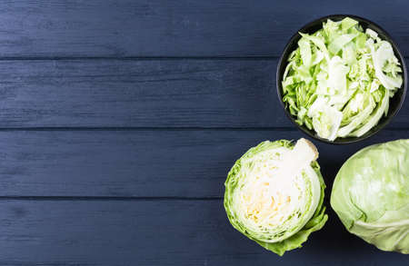 Ripe green cabbage sliced on dark wooden backgroundの写真素材