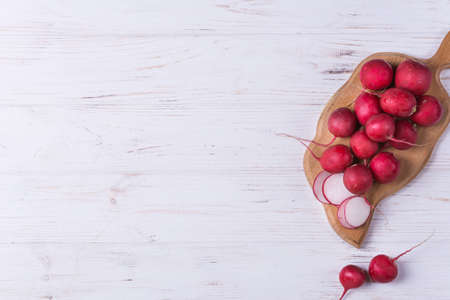 Ripe fresh radish on white wooden backgroundの写真素材