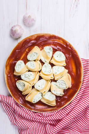 Delicious lumaconi pasta meal with cheese and tomato sauceの写真素材